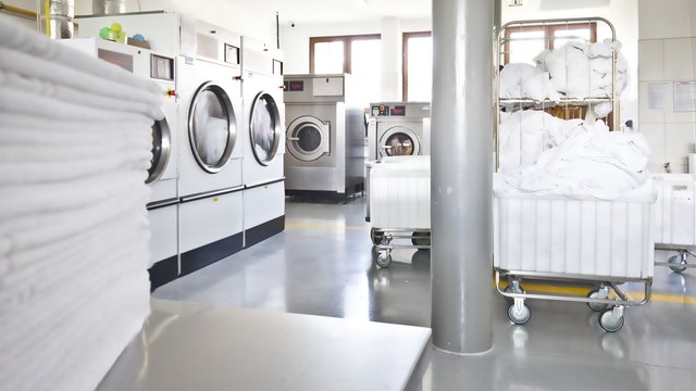 Big industrial laundry washing machines clean zone bright modern interior