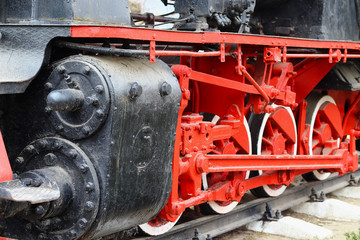 Metal wheels of a steam locomotive on a railway, background