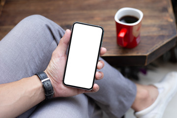 Mockup image blank white screen cell phone.man hand holding texting using mobile on desk at coffee shop.background empty space for advertise text.people contact marketing business,technology