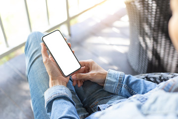 Mockup image blank white screen cell phone.woman hand holding texting using mobile on desk at coffee shop.background empty space for advertise text.people contact marketing business,technology