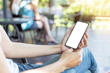 Mockup image blank white screen cell phone.woman hand holding texting using mobile on desk at coffee shop.background empty space for advertise text.people contact marketing business,technology