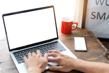 mockup image blank screen computer,cell phone with white background for advertising text,hand man using laptop texting mobile contact business search information on desk in cafe.marketing,design