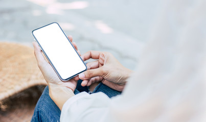 Mockup image blank white screen cell phone.woman hand holding texting using mobile on desk at coffee shop.background empty space for advertise text.people contact marketing business,technology