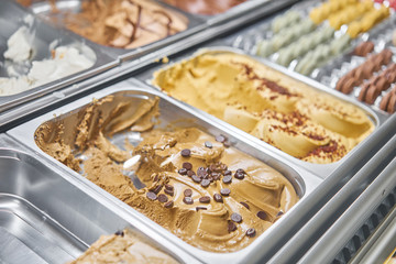 Coffee Gelato. Flavors various ice cream in Rome, Italy. Italian gelateria. Assortment of colorful gelato on cafe showcase. Natural fresh ice cream.