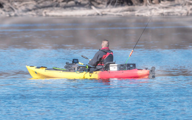 People is kayaking, boating and fishing at Mississippi River on early spring of Minnesota