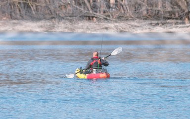 People is kayaking, boating and fishing at Mississippi River on early spring of Minnesota