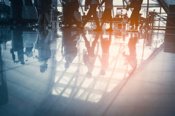 Silhouette crowded traveler walking in airport terminal, Reflect of passenger with luggage in departure or arrival in airport