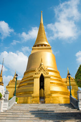 Naklejka premium View of Phra Si Rattana Chedi - gold stupa near Temple of Emerald Buddha. Grand Palace, Bangkok, Thailand