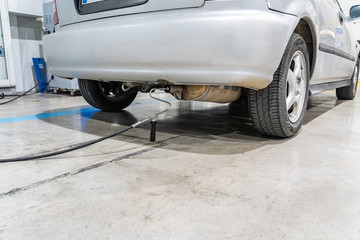 Emission control in the exhaust of an old car at a vehicle inspection station