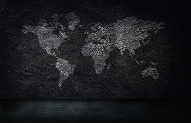 Abstract image of World map on concrete wall texture background in dark room.