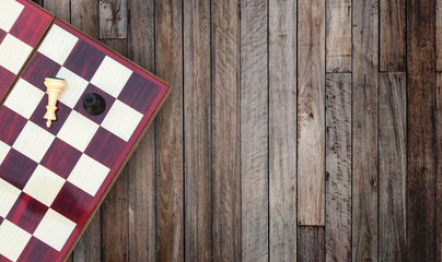 Fototapeta na wymiar Business Competition Concept : Top view portable chess board on wooden table.