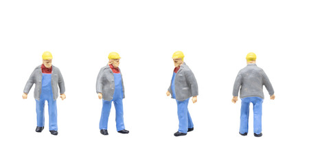 Miniature figurine character as railway track worker posing in posture isolated on white background.