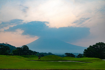 Sunrise view of the volcano called Agua, in Guatemala from a golf course called the Reunion destroyed by the volcano called Fuego in Central America.