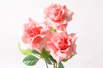 Pink colorful textile rose closeup on white background