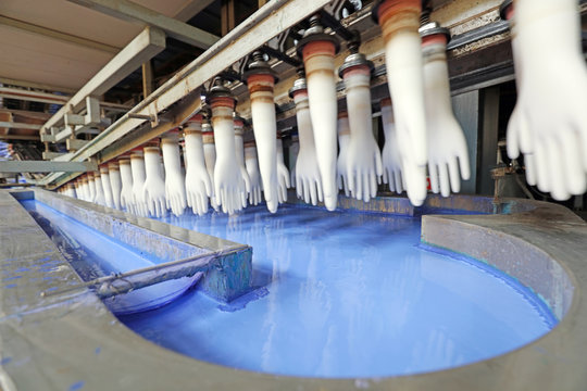 View of nitrile butadiene gloves on conveyor belt in factory