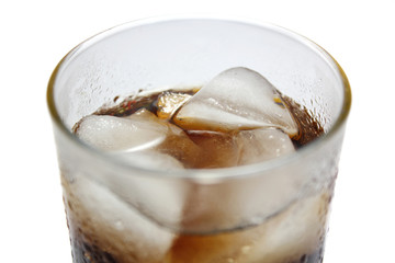 Close up view of cold cola with ice cubes, refreshment drinks in a glass with white background