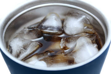 Close up view of cold cola with ice cubes, refreshment drinks in a glass with white background