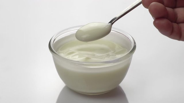 Closeup shot of mixing yogurt with spoon