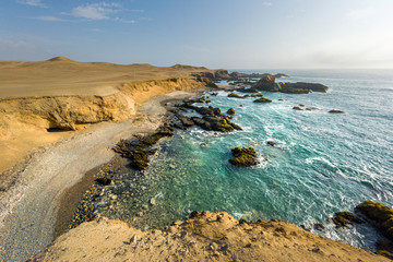 Panoramic view of a rocky beach with green-blue seawater at Huarmey´s seaside in Ancash region, Peru