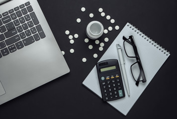 Doctoral supplies and tools, calculator on black background. Economic calculation of the effectiveness of healthcare and medicine. Doctor workspace
