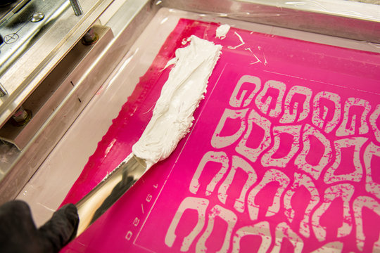 Spreading ink in a printing screen for screen printing t-shirts or posters