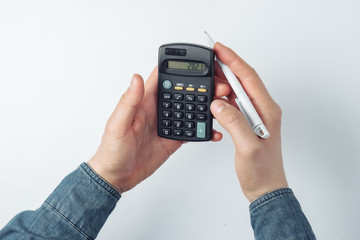 Male hands count on a calculator on white background
