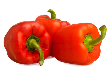  three red bell peppers on a white background
