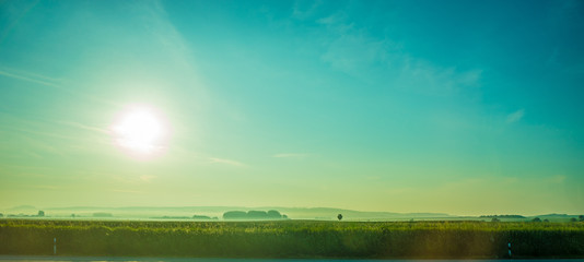 Germany, Frankfurt, Sunrise, a large green landscape with a body of water
