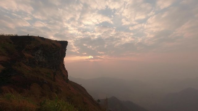 Time lapse of beautiful sunrise at Phu Chi Fah National Park, A tourist destination on a hilltop during the foggy and beautiful light in the morning and sunset in Chiang Rai Thailand 