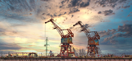 Massive blue, orange and yellow cranes in harbour