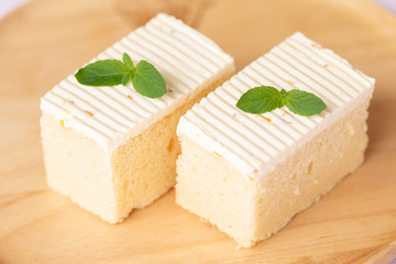 Sliced of cheesecake with  mint leaves decorated on top
