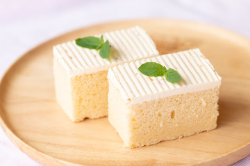Sliced of cheesecake with mint leaves decorated on top.