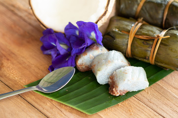 Thai traditional dessert Sticky Rice with Bananas (Khao Tom Mat) on wooden background