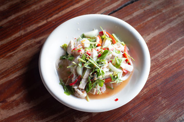 Pork sausage spicy salad on wooden table