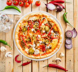 tasty pizza on the wooden background