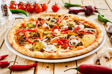 tasty pizza on the wooden background
