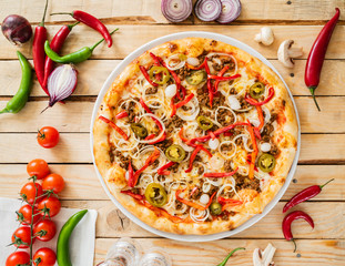 tasty pizza on the wooden background