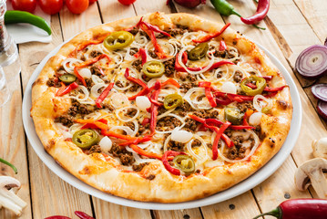 tasty pizza on the wooden background