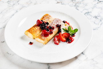 pancakes with strawberries and mint