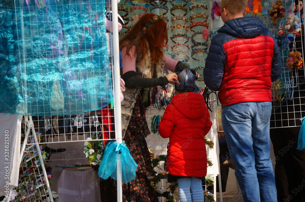 Wall mural People buy Souvenirs in the recreation Park. The father of a child.