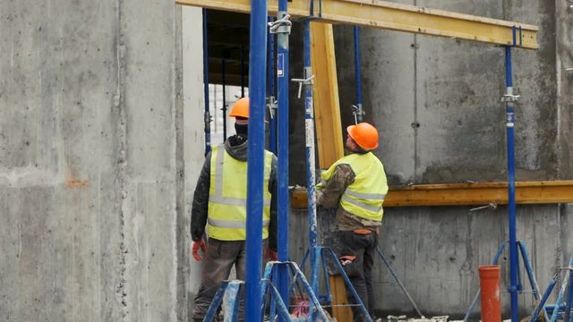 Builder working on construction. Erector