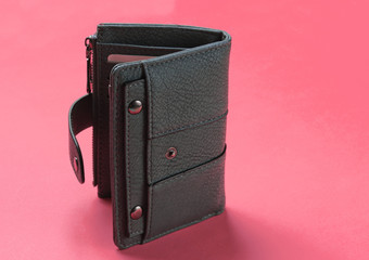 Open leather wallet with credit cards on pink background