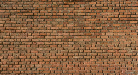 Detail of a house´s wall made of red bricks at a sunny day