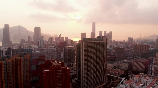 Sunset 4K UHD aerial drone rotation over buildings