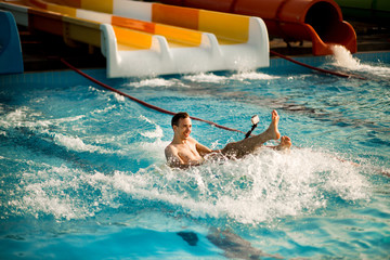 Happy person has active summer vacation activities at the water park.