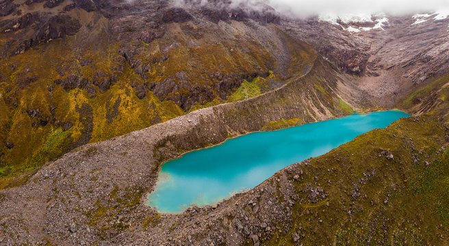 Aerial view of the Cancaraga lake, a turquoise water body located in the White Range on the way to Chacas town in Ancash Region, Peru