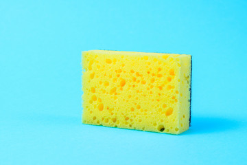 One yellow wash sponge on blue background.