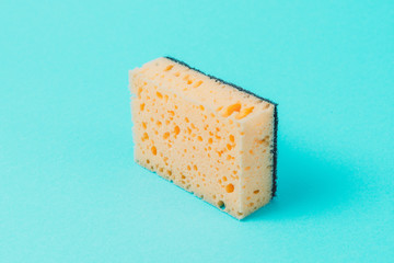 One yellow wash sponge on blue background.