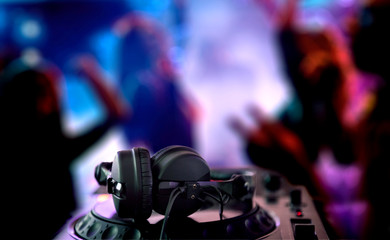 Fototapeta na wymiar DJ Spinning, Mixing, and Scratching in a Night Club. DJ playing music at mixer . Closeup. Party.