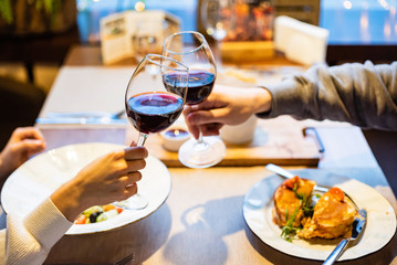 Man and woman drinking red wine in the restaurant